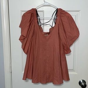 Peach colored women’s off the shoulder top